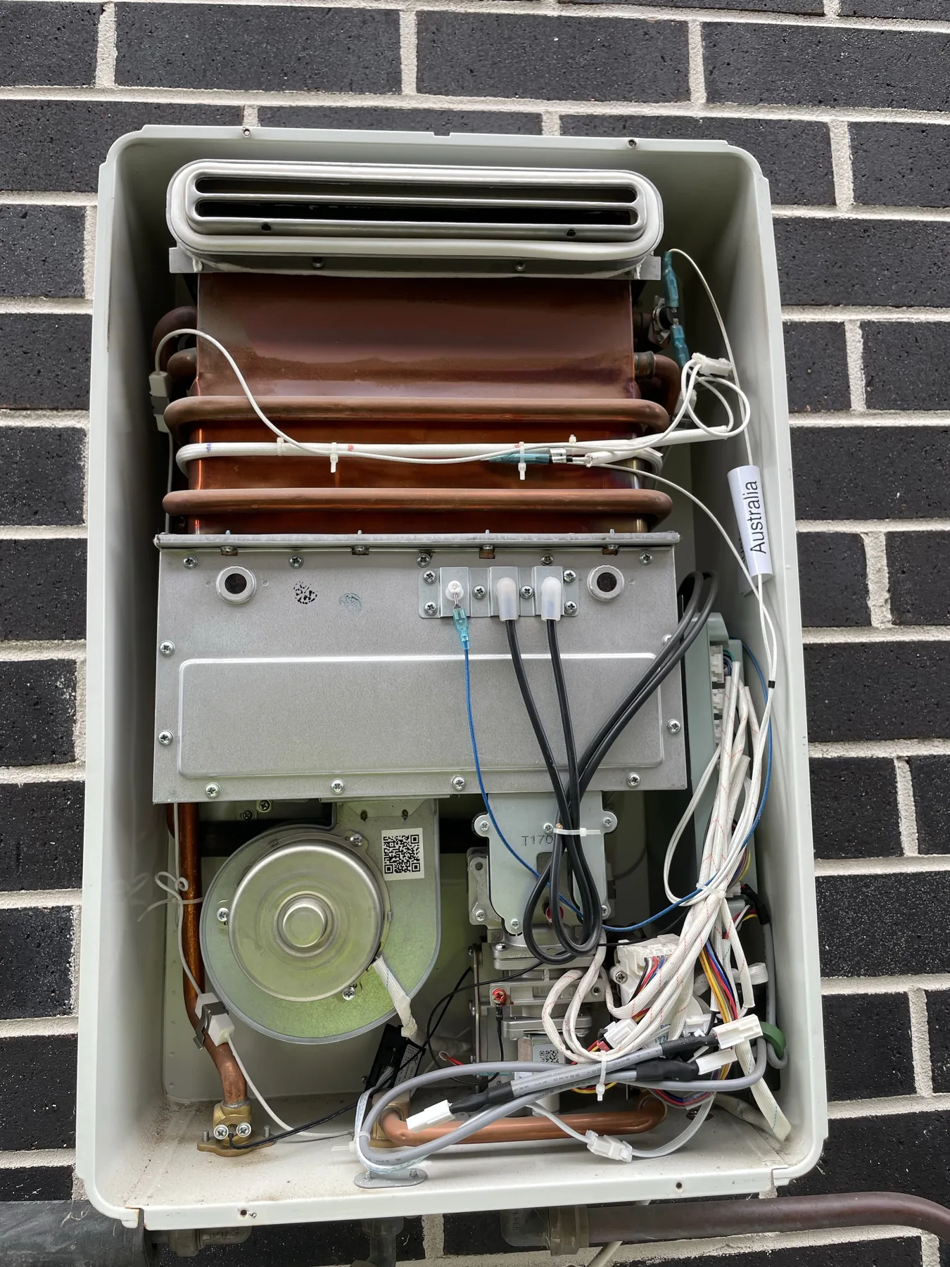 Rear appliance service panel removed to expose internal components