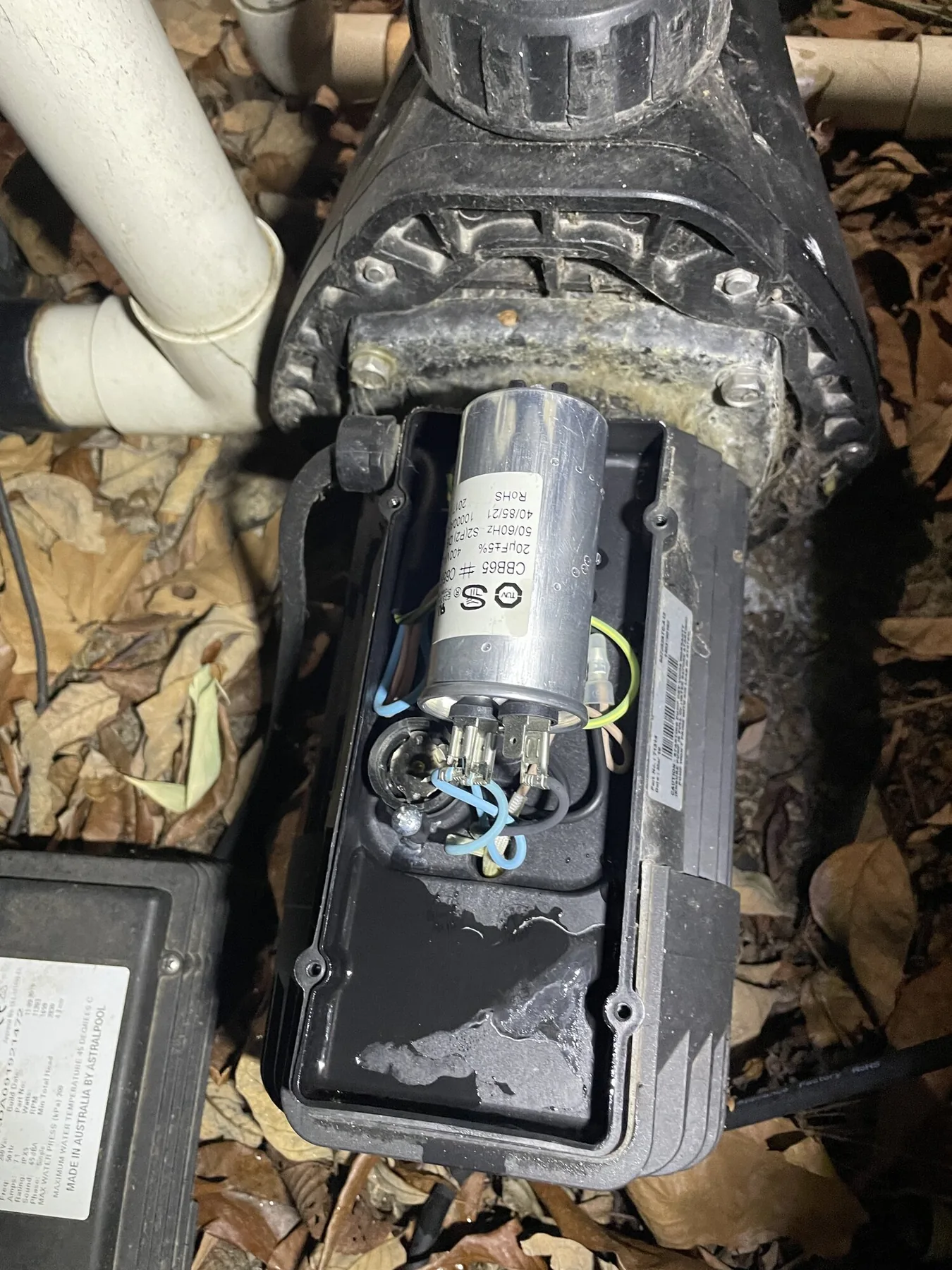 Appliance motor and capacitor assembly exposed for assessment