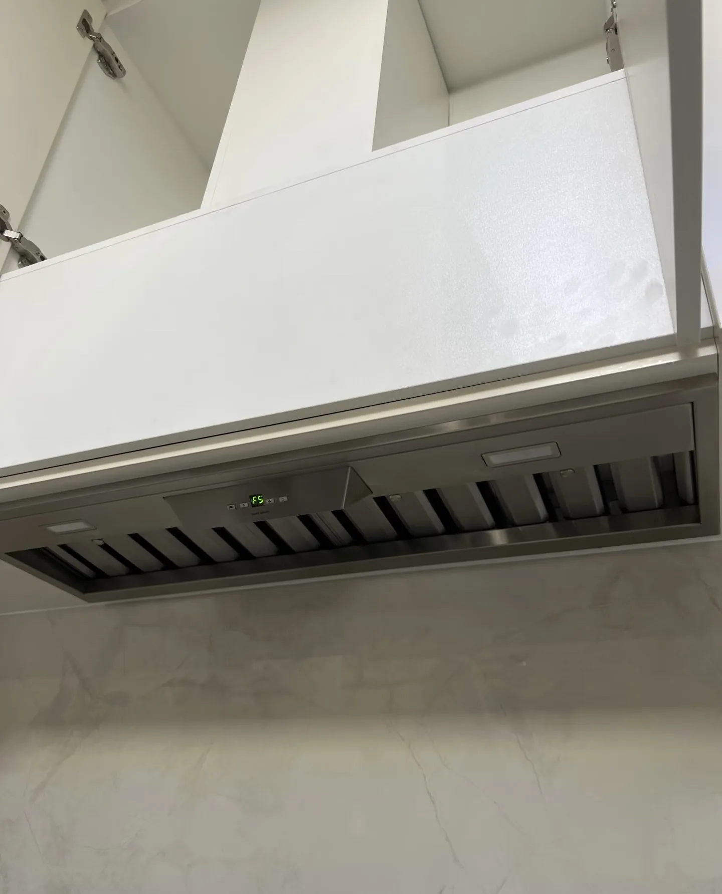 Close view of rangehood filters and control area