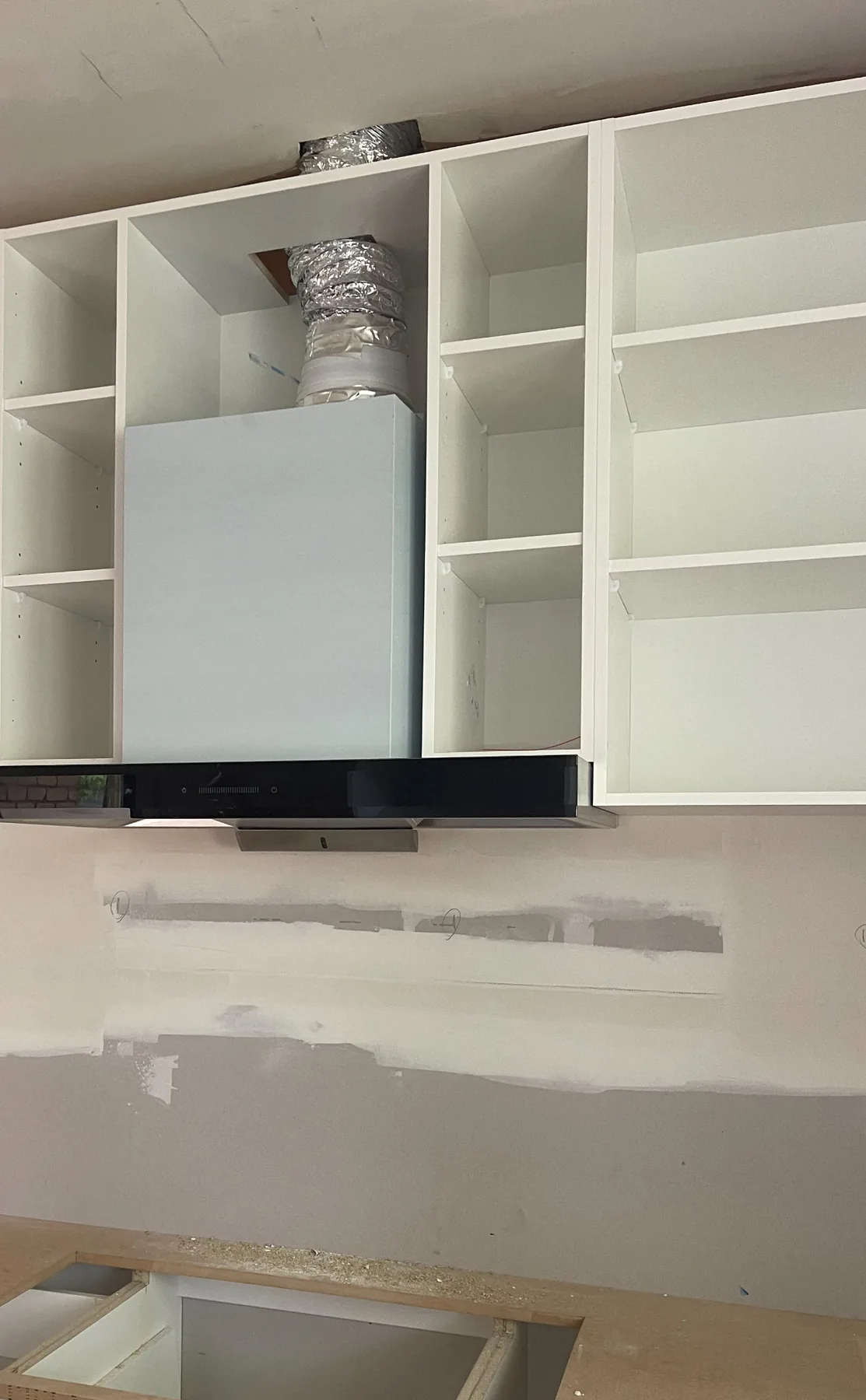 Installed stainless steel rangehood in a home kitchen