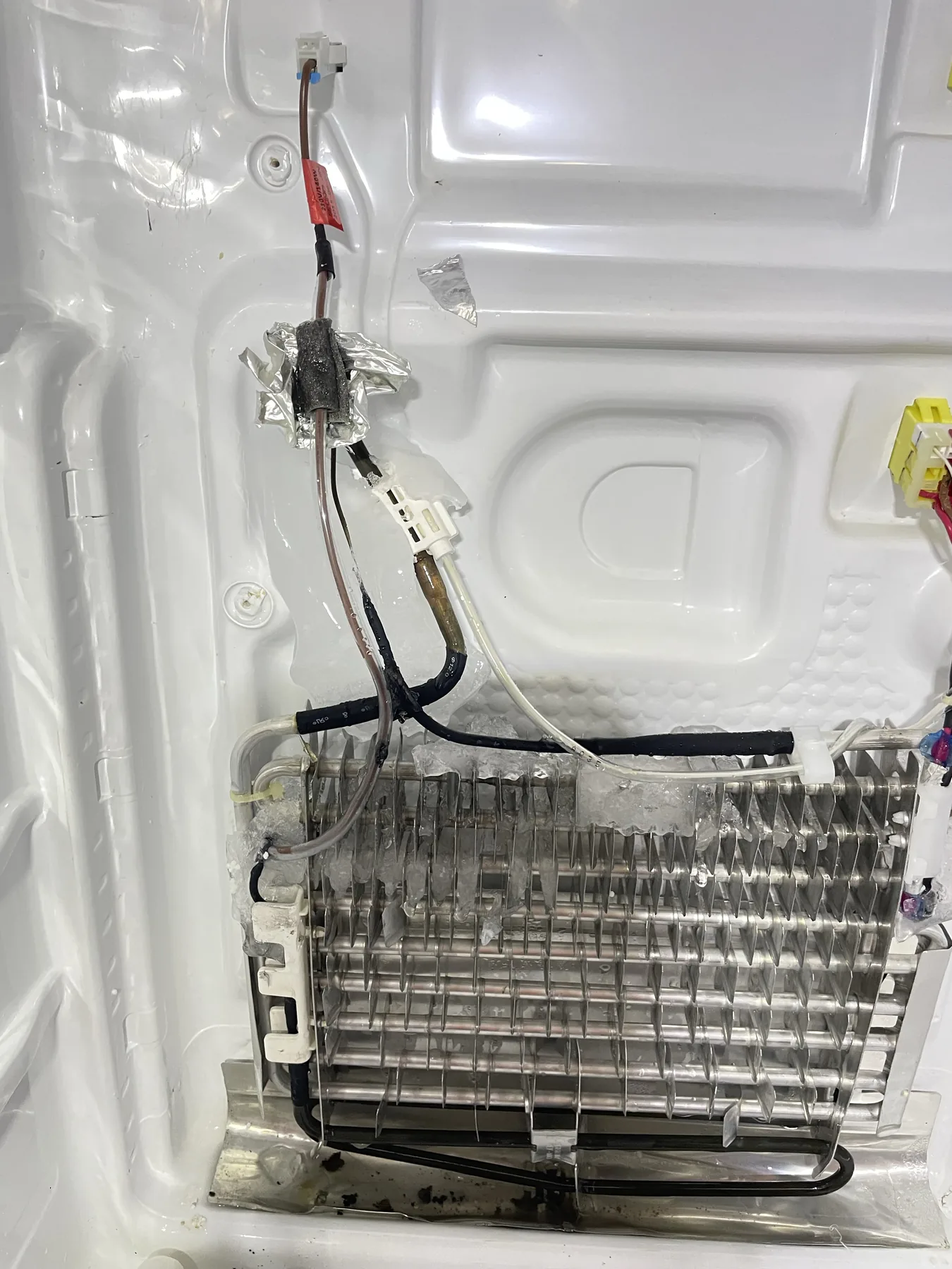 Refrigeration evaporator and internal wiring visible during service access
