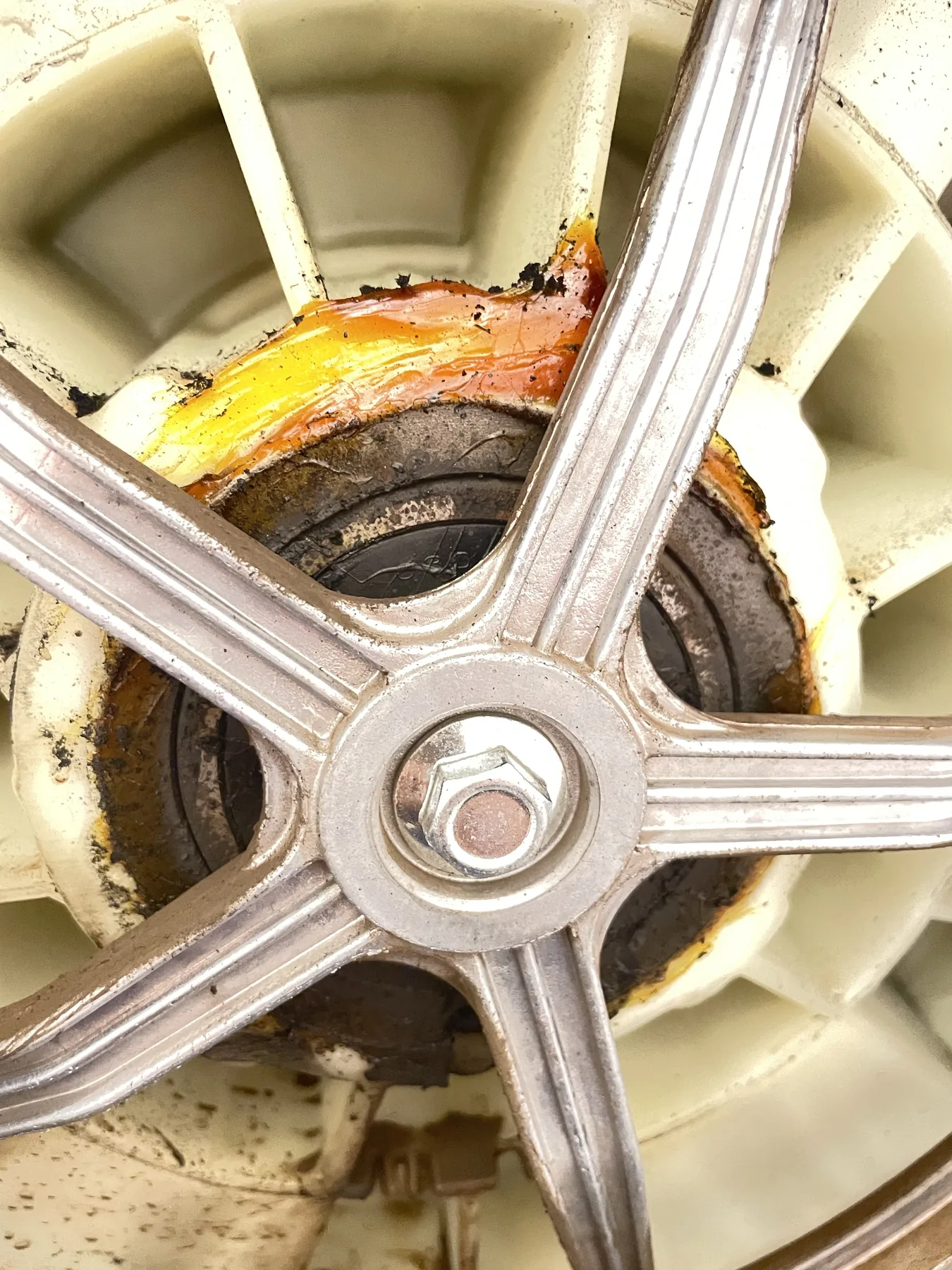 Washing machine bearing area showing visible wear and residue